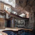 Modern Cave Villa Built into a Massive Rock with Underground Grotto