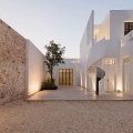 Modern Villa with Exterior Spiral Staircase in Rustic Courtyard