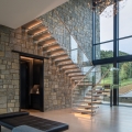Sleek Minimalist Mountain Residence with Transparent Floating Staircase