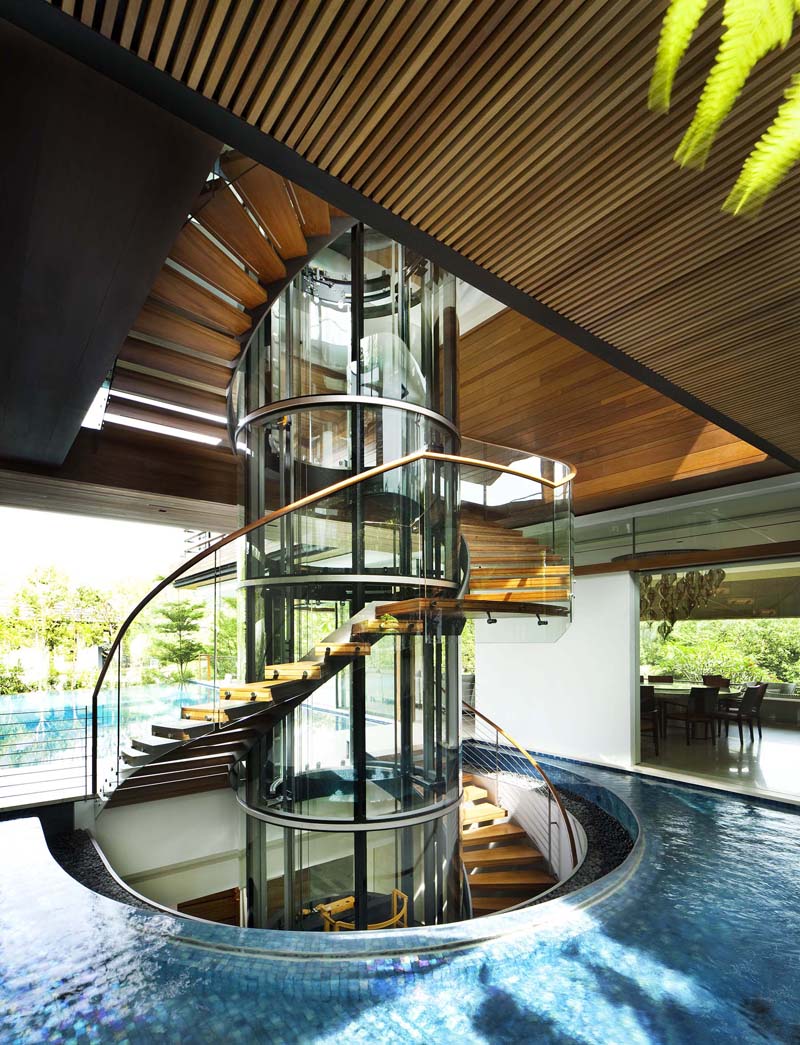 Modern Tropical Home in Singapore with Spiral Staircase Wrapped Around a Glass Elevator