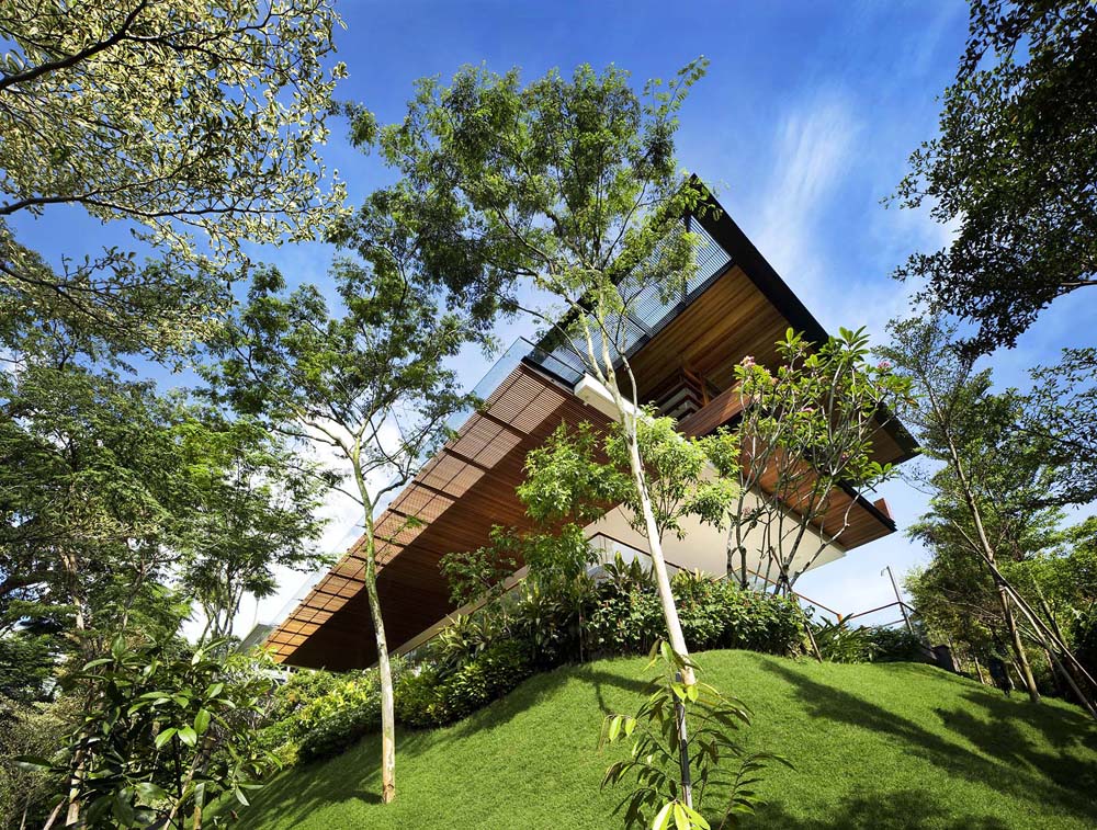Modern Tropical Home in Singapore with Spiral Staircase Wrapped Around a Glass Elevator