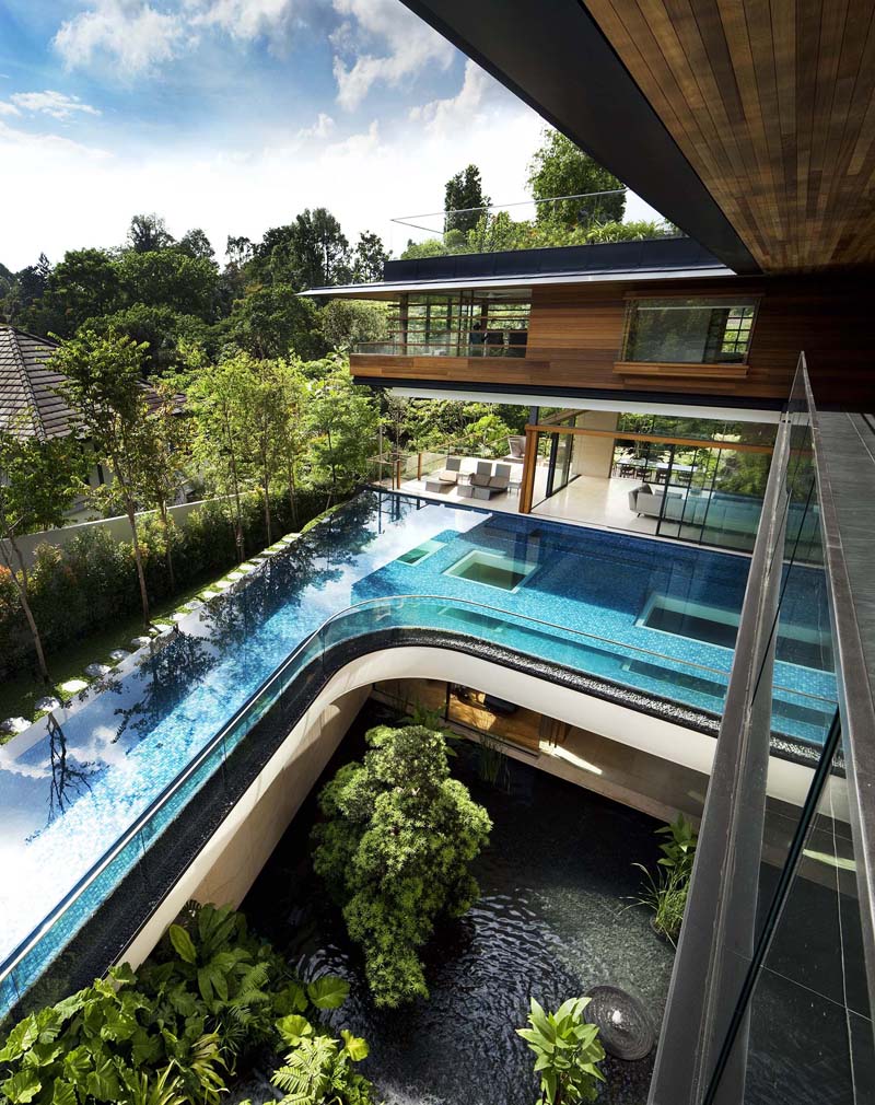 Modern Tropical Home in Singapore with Spiral Staircase Wrapped Around a Glass Elevator