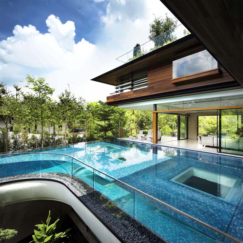 Modern Tropical Home in Singapore with Spiral Staircase Wrapped Around a Glass Elevator