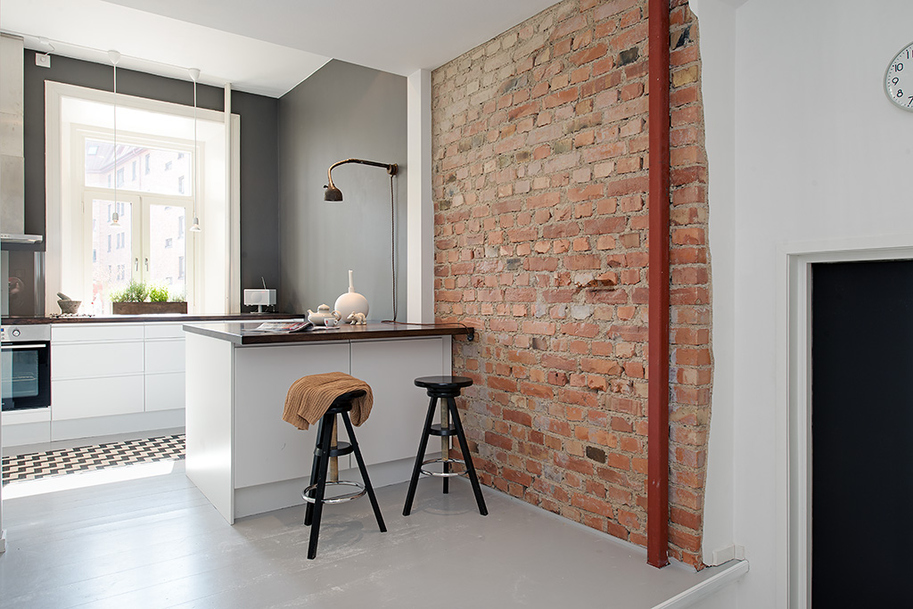 Custom-Loft-Gothenburg_17 Modern White Kitchen with Rustic Brick Wall