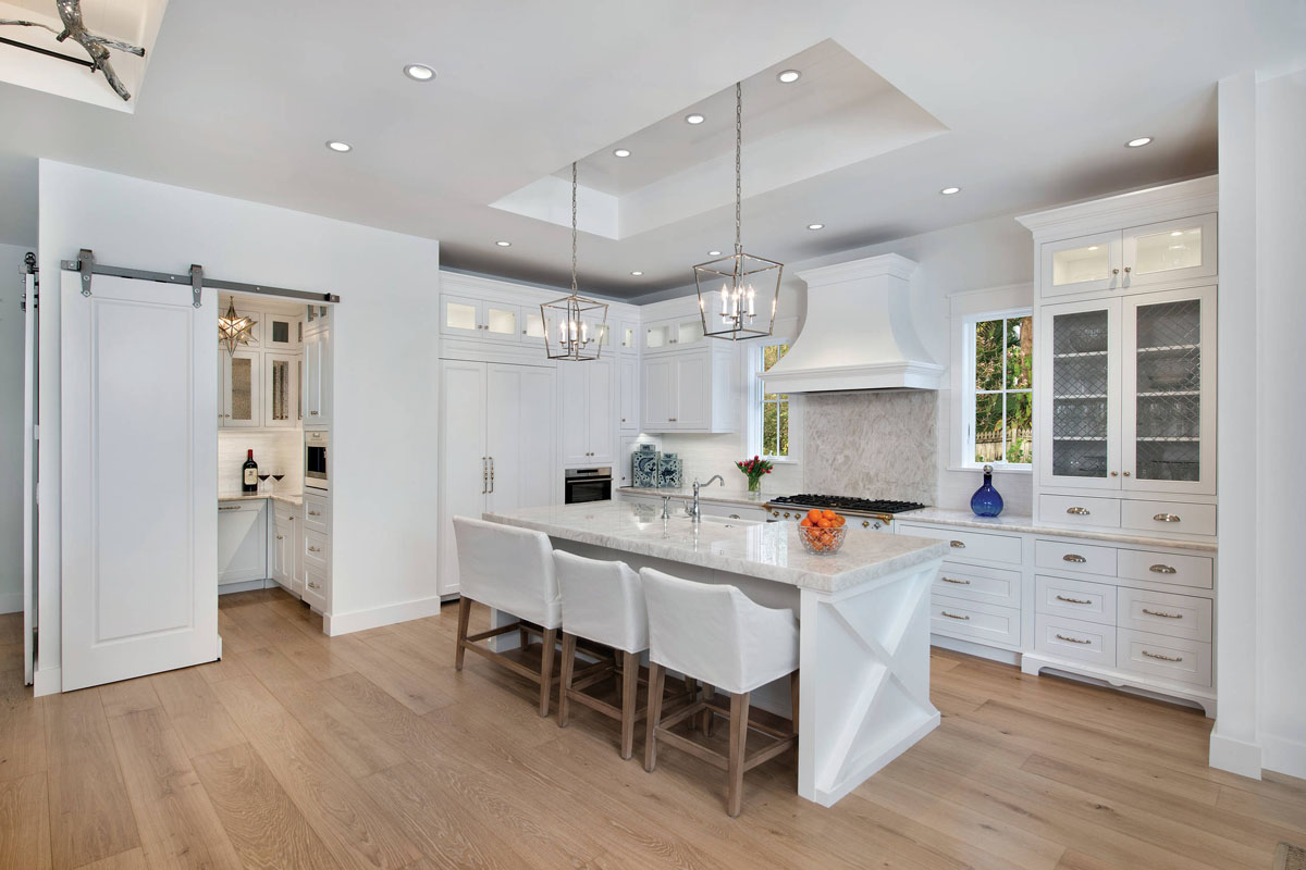 Beach Style Modern Home - Naples, Florida A Barn Door Opens to the Butler’s Pantry