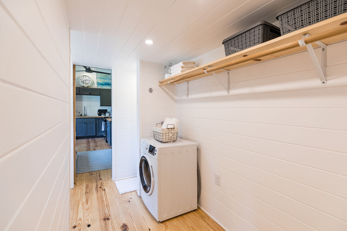 Tiny House on Wheels with Clean Transitional Design Tiny House Laundry Room with Storage Space