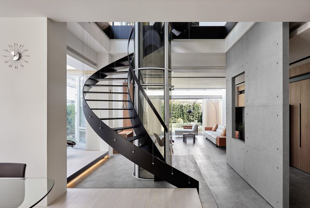 Modern Home with Transparent Floors and Spiral Staircase Wrapped Around a Glass Elevator