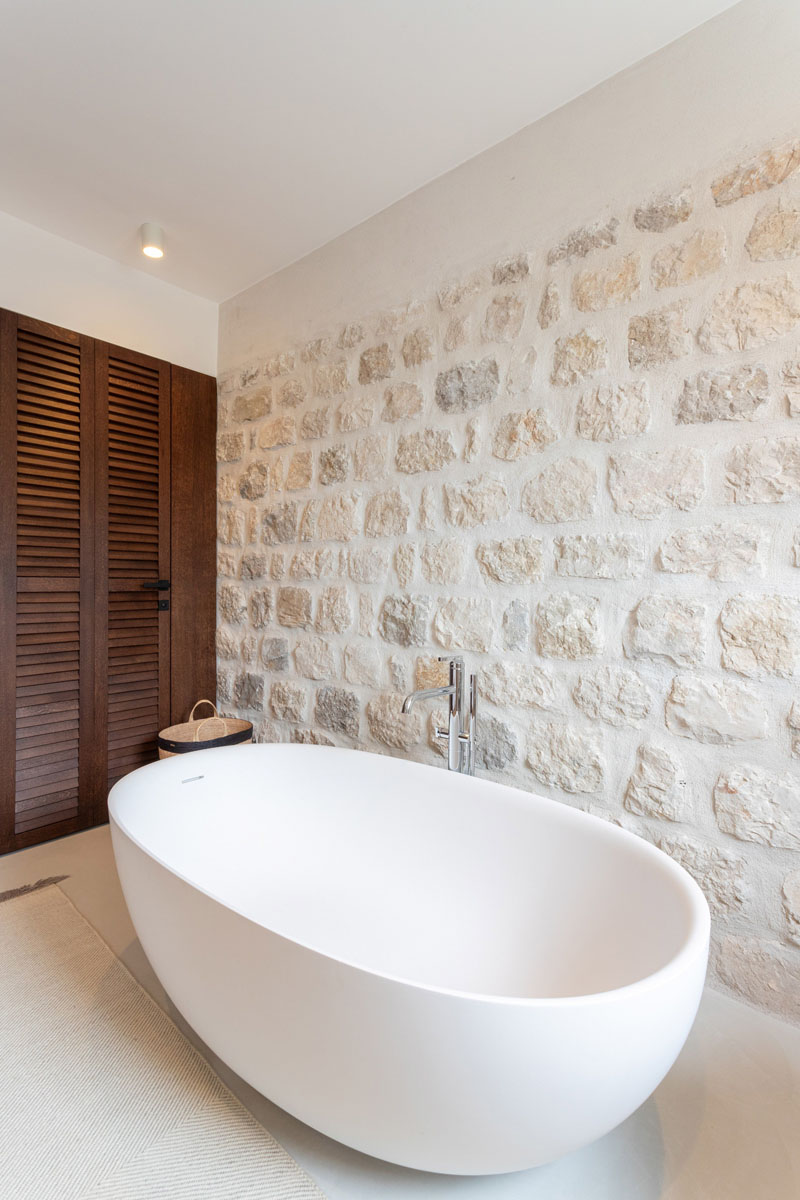Charming Modern Renovation of House with Stone Walls Bathroom with Stone Wall