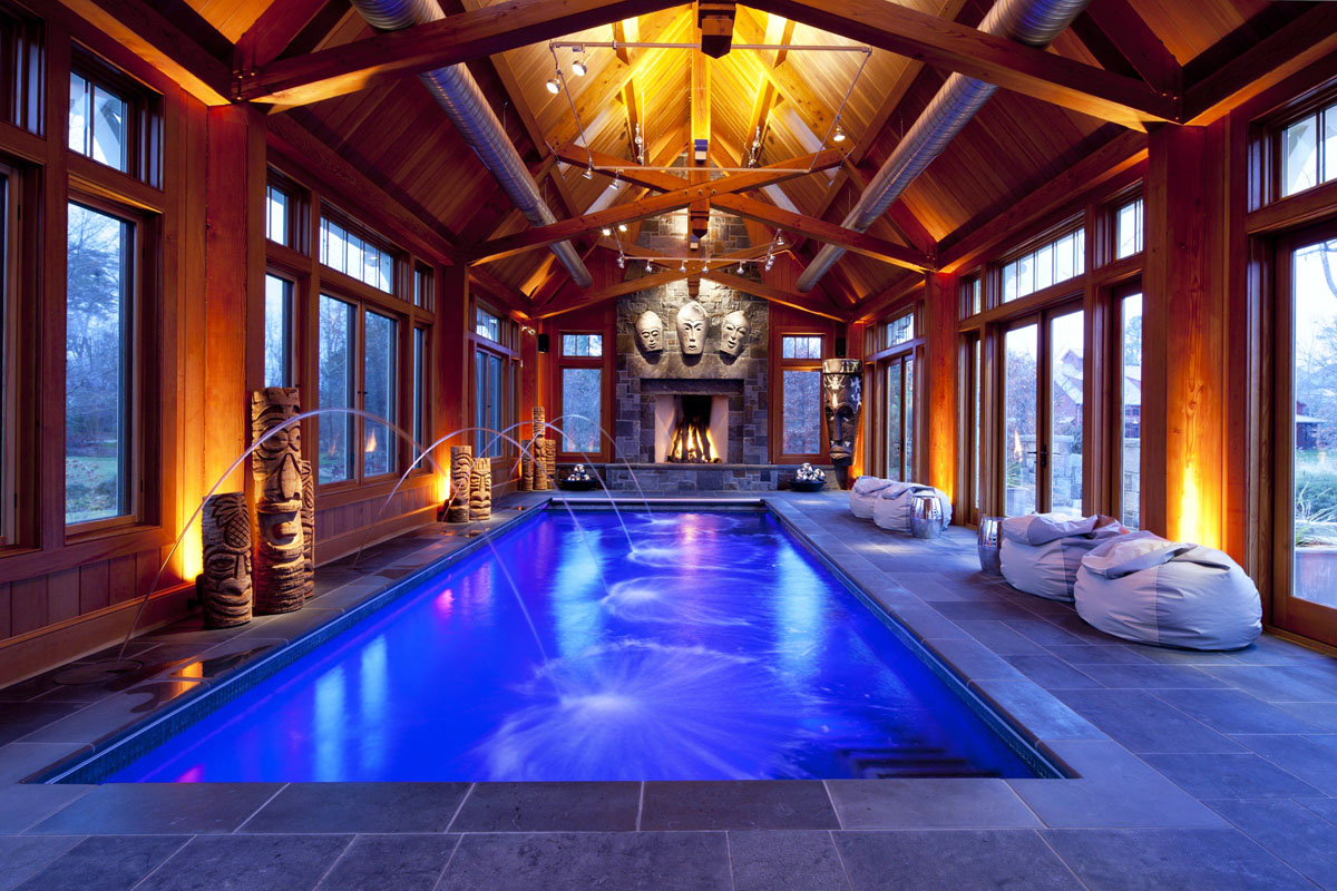 Stone and Timber-Frame Indoor Swimming Pool with Large Stone Fireplace