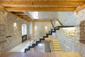Rustic Stone Wall and Modern Glass Staircase