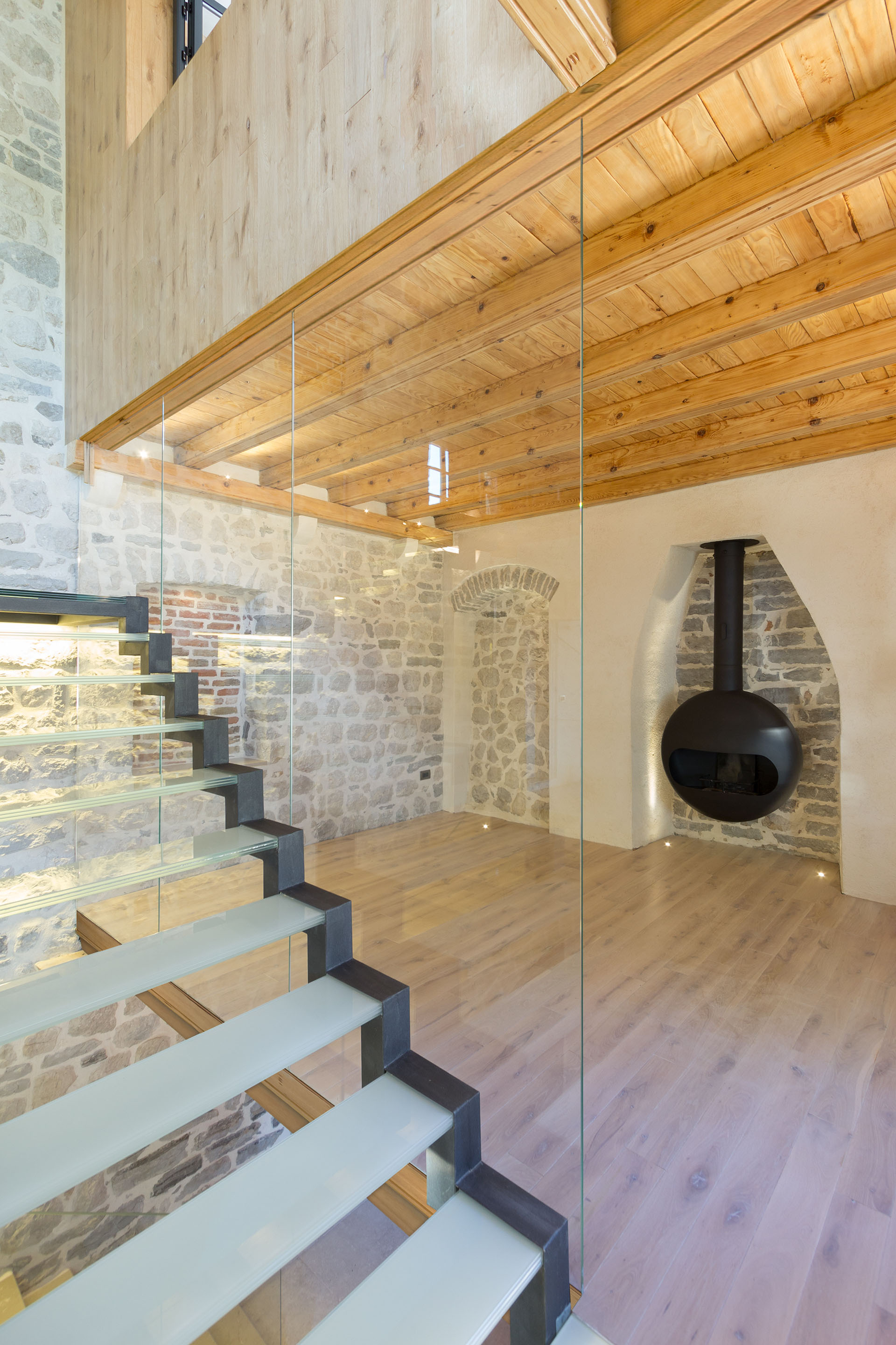 Villa-Monja-Montenegro_8 Living Room with Stone Walls, Fireplace, Natural Wood Floor and Glass Stairs