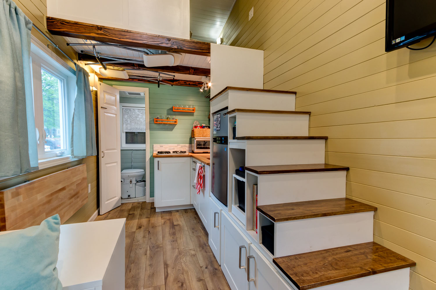Wanderlust-Tiny-House-on-Wheels_5 Tiny House Interior with Storage under the Staircase
